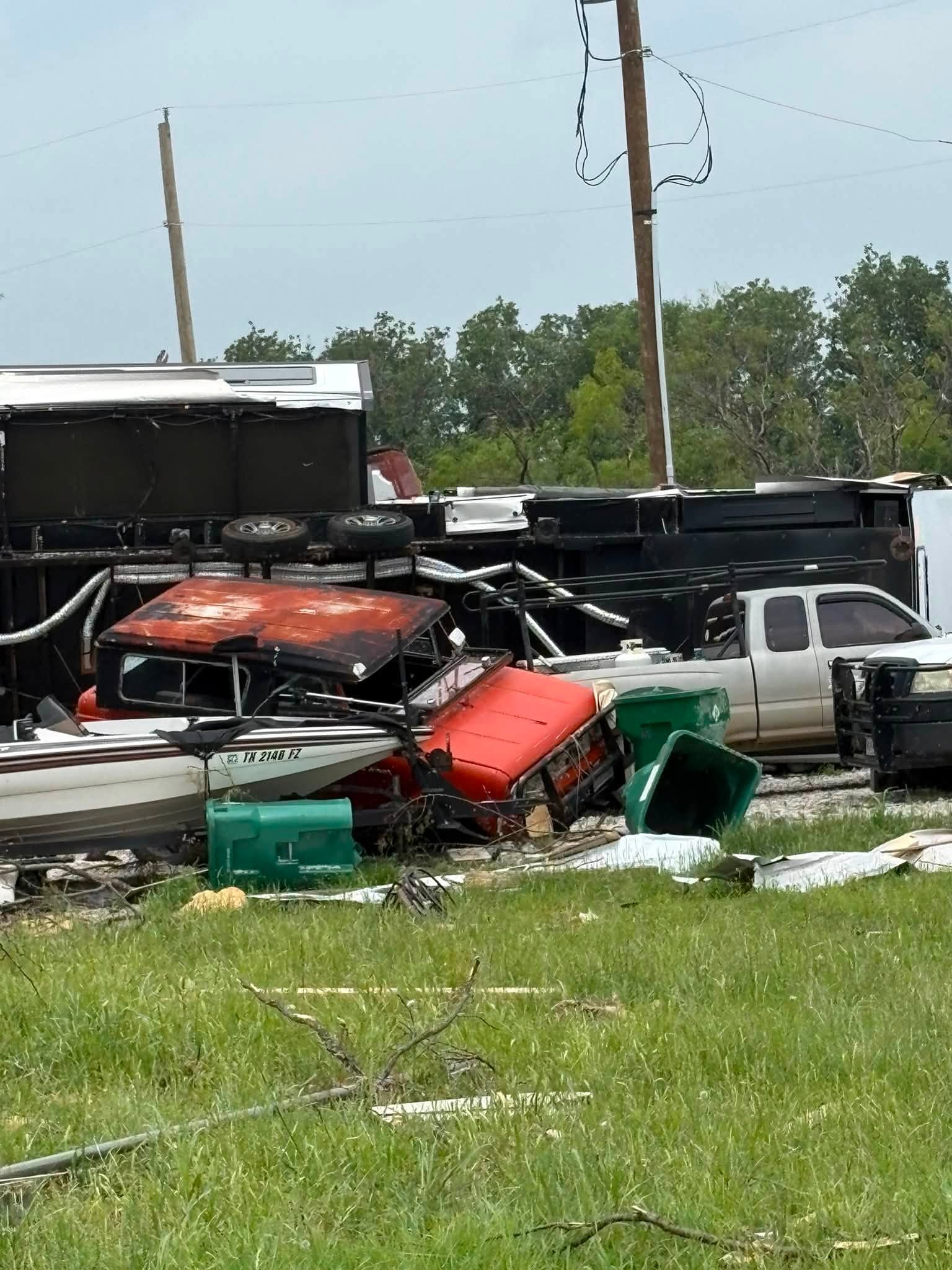 Damaged vehicles and debris photographed in Runaway Bay during Trip #78.