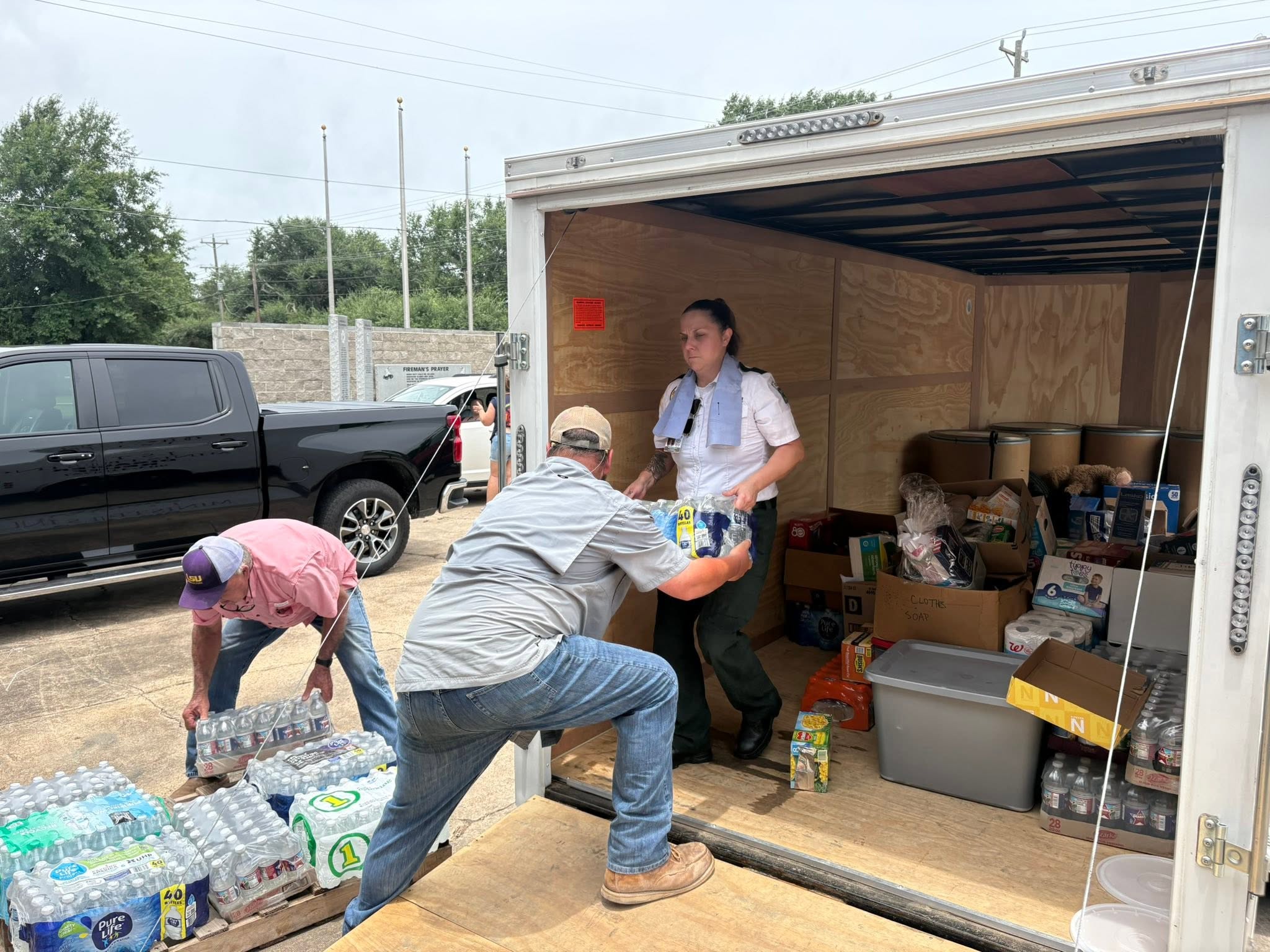 Volunteers unload bottled water from the J-STAR trailer in Avoyelles Parish.