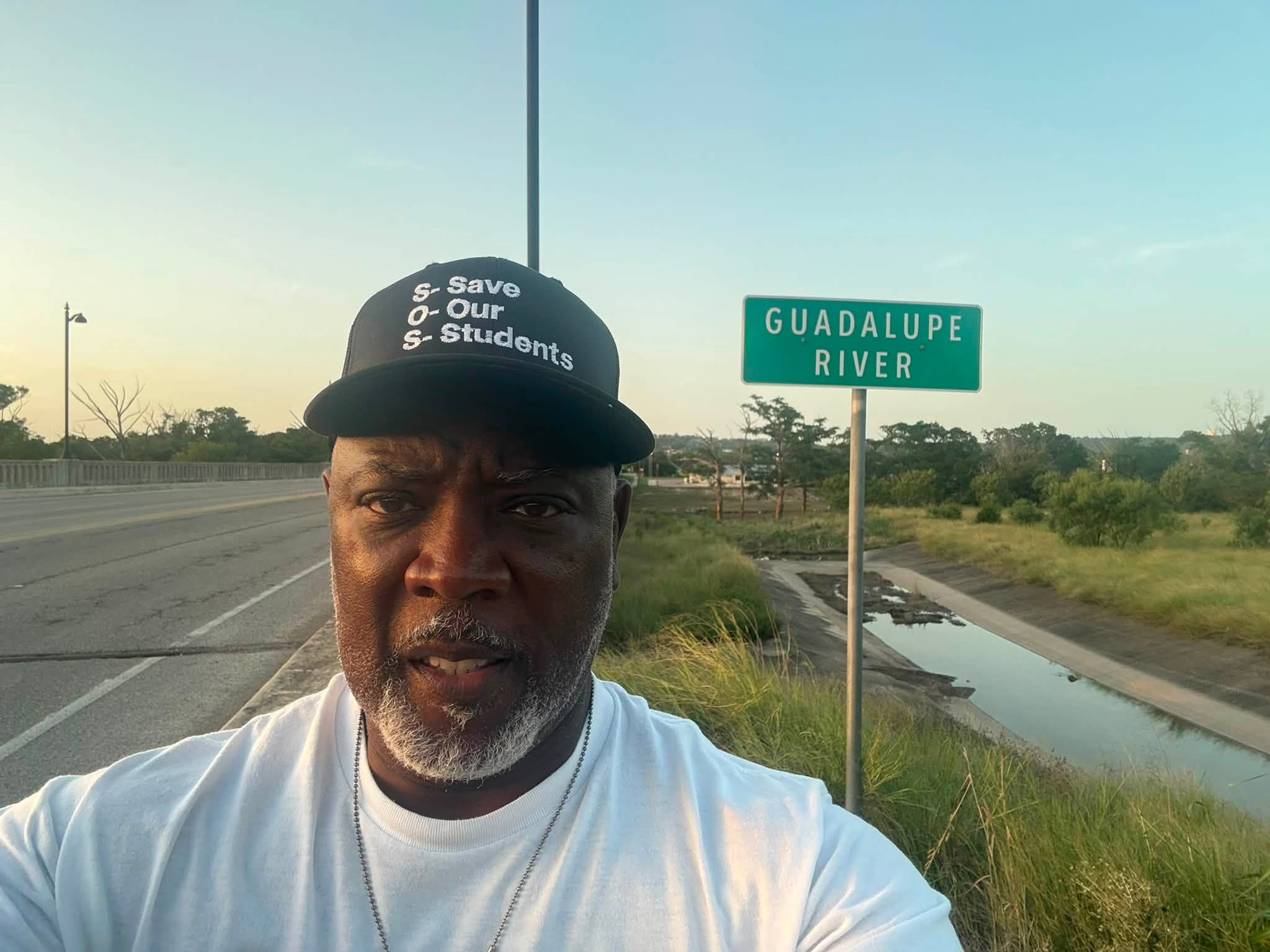 Patrick beside the Guadalupe River sign during his Kerrville return.