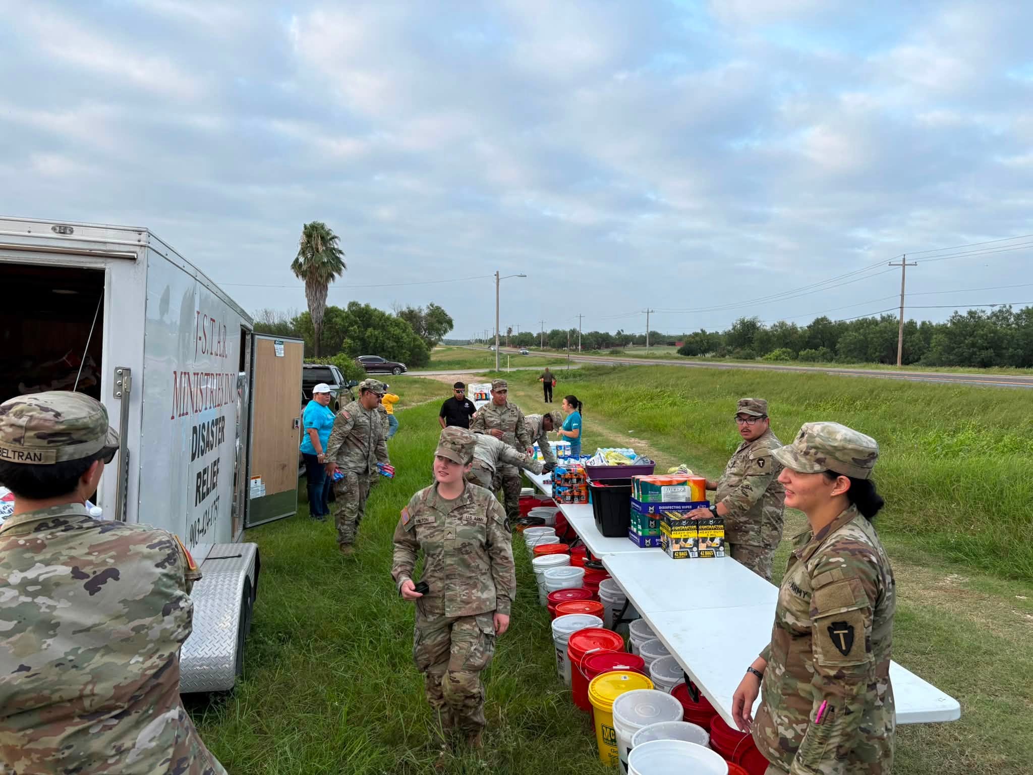 The relief team sets out donated supplies beside the J-STAR trailer in Crystal City.
